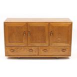 Ercol Windsor light elm sideboard with three cupboard doors above two drawers, 76cm H x 130cm W x