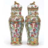 Pair of Chinese Canton porcelain baluster vases and covers, hand painted in the famille rose palette