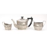 Victorian silver three piece tea service, embossed with flowers, by William Henry Leather,