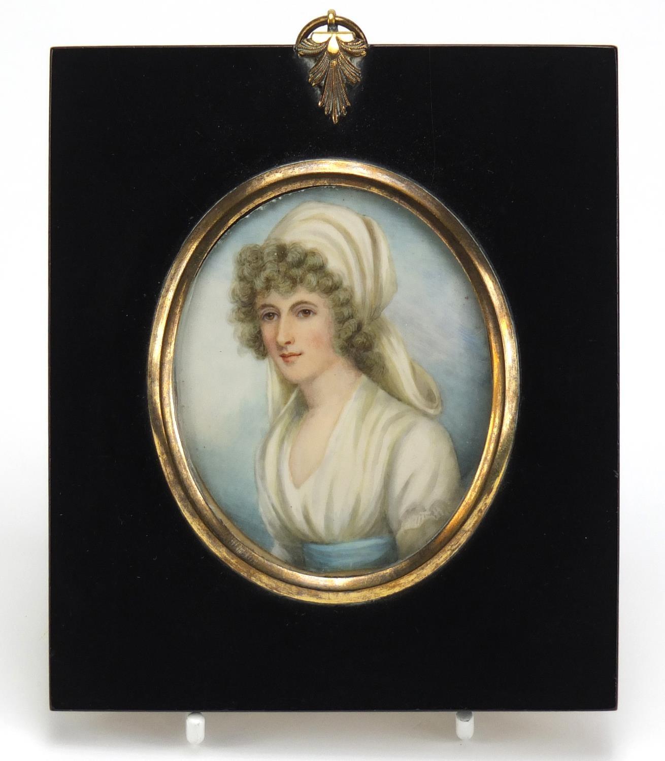 19th Century oval hand painted portrait miniature of a young female, housed in an ebonised frame,