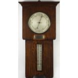 Art Deco oak wall aneroid barometer and thermometer with an applied silver plaque with
