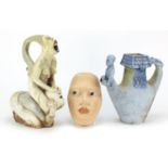 Studio pottery face mask of a female and two surreal Studio pottery jugs by George Walker, the