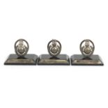 Three British military interest unmarked silver and ebony menu holders, retailed by Goldsmiths &