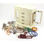 Costume jewellery including cameos, amber coloured beads, necklaces, bracelets, brooches, earrings