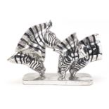 Silvered sculpture of four zebra heads, 43cm in length :For Further Condition Reports Please visit