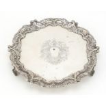 Circular silver three footed salver, pierced and embossed with flowers, by Wakely & Wheeler London