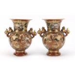 Pair of Japanese Satsuma pottery vases with twin handles, hand painted with figures and dragons,