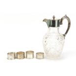Four silver napkin rings and a cut glass claret jug with silver plated mounts, the largest 23cm high