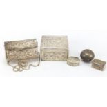 Four Islamic silver coloured metal boxes and a clutch bag, each pierced and embossed with birds of