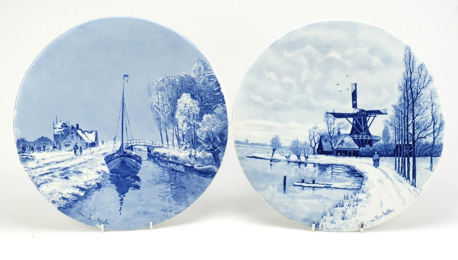 Two Dutch Delft plaques including one hand painted with a figure before a windmill by Chattel,