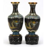 Pair of Chinese Cloisonne vases raised on carved hardwood stands, each enamelled with dragons