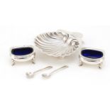 Silver shell shaped dish and a pair of silver open salts with blue glass liners, various