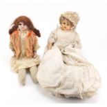 Two 19th century dolls with composite limbs, wearing traditional dress :For Further Condition