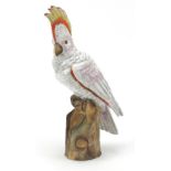 German hand painted porcelain cockatoo perch on a trunk, 34cm high :For Further Condition Reports