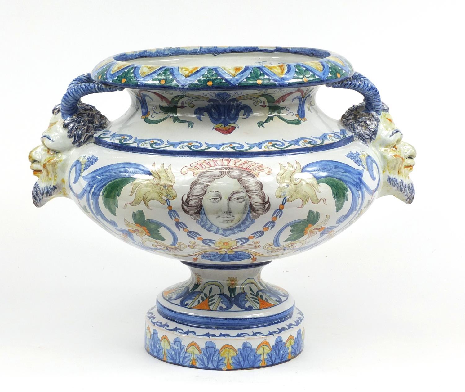 Large continental Faience glazed pottery centrepiece with twin handles, hand painted with mythical