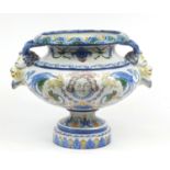 Large continental Faience glazed pottery centrepiece with twin handles, hand painted with mythical