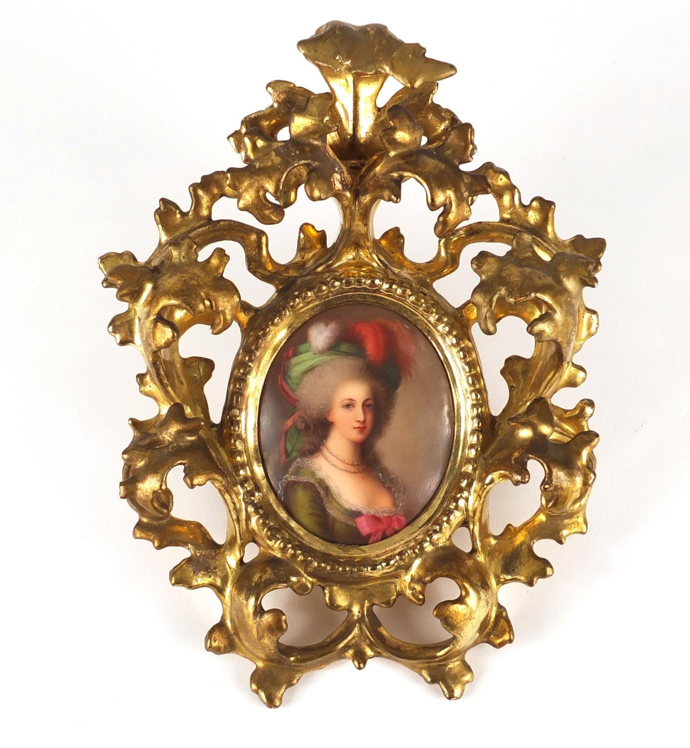 19th century oval porcelain plaque, hand painted with a female housed in a carved gilt wood frame