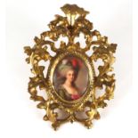 19th century oval porcelain plaque, hand painted with a female housed in a carved gilt wood frame