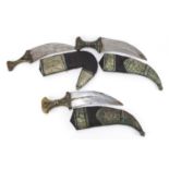 Three Islamic Jambiya daggers with horn handles and leather sheaths having applied white metal