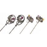 Two pairs of unmarked silver thistle design hat pins set with amethyst and citrine, the largest 28.