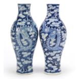 Pair of Chinese blue and white porcelain vases, hand painted with dragons amongst clouds chasing a