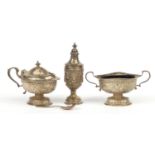 Victorian silver three piece cruet embossed with rams heads and swags, Birmingham 1905, the