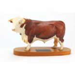 Beswick connoisseur model of a Hereford Bull, raised on a wooden plinth base, 34cm wide :For Further