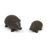 Two Japanese patinated bronze hedgehogs, one with impress character marks to the underside, the