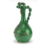 Turkish Canakkale green glazed pottery ewer with applied flower heads, 39cm high :For Further