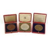 Three commemorative coronation medals with fitted tooled leather cases, comprising the coronation of