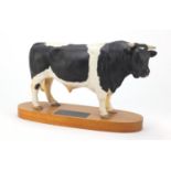 Beswick connoisseur model of a Friesian bull, raised on a wooden plinth base, 31cm wide :For Further