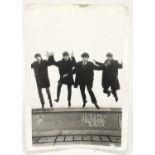 Vintage black and white photograph of the Beatles jumping, 30.5cm x 23.5cm :For Further Condition