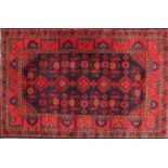 Rectangular Persian blue and red ground rug having a geometric design, 175cm x 115cm :For Further