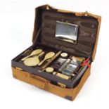 Silver and guilloche enamel travelling vanity set, housed in a brown leather fitted case, by Padgett