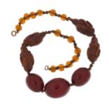 Chinese cherry amber coloured bead and carved coquilla nut necklace, 40cm in length :For Further