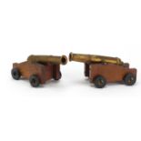 Two bronzed model cannons on wooden stands, each 17.5cm in length :For Further Condition Reports