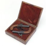 Pair of 19th century pocket percussion pistols, housed in a velvet lined fitted case hand painted