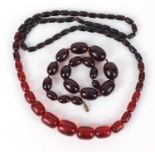 Two cherry amber coloured bead necklaces, the largest 90cm in length, 147.0g :For Further