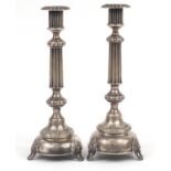 Pair of Russian silver candlesticks by I Szekman, each embossed with fruiting vines, 31cm high,