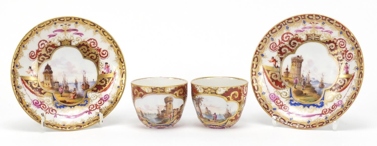 Pair of 19th century Meissen cabinet cups and saucers, each finely hand painted with panels of