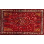 Rectangular Persian red ground rug having an all over geometric design, 210cm x 126cm :For Further
