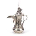 Omani silver coloured metal Dallah coffee pot embossed with flowers, 32cm high, 781.4g :For