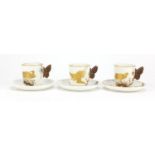 Three aesthetic Worcester coffee cans and saucers with butterfly design handles, each gilded with
