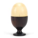 Stained ivory egg cup with an ivory half egg, 9cm high :For Further Condition Reports Please visit