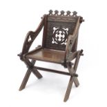 Gothic style oak hall chair with X-frame support carved with foliage, 88cm high :For Further