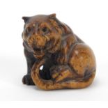 Good Japanese carved boxwood Netsuke of a tiger, character marks to the base, 3.7cm high :For