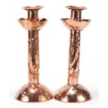 Pair of Arts & Crafts copper candlesticks embossed with fish by Newlyn, each 21.5cm high :For