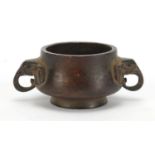 Chinese patinated bronze incense burner with elephant head handles, character marks to the base, 8cm