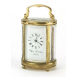 Miniature brass cased oval carriage clock by Charles Frodsham of London, 8.5cm high :For Further