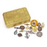 British military World War I brass Mary tin, together with a group of military brooches and badges